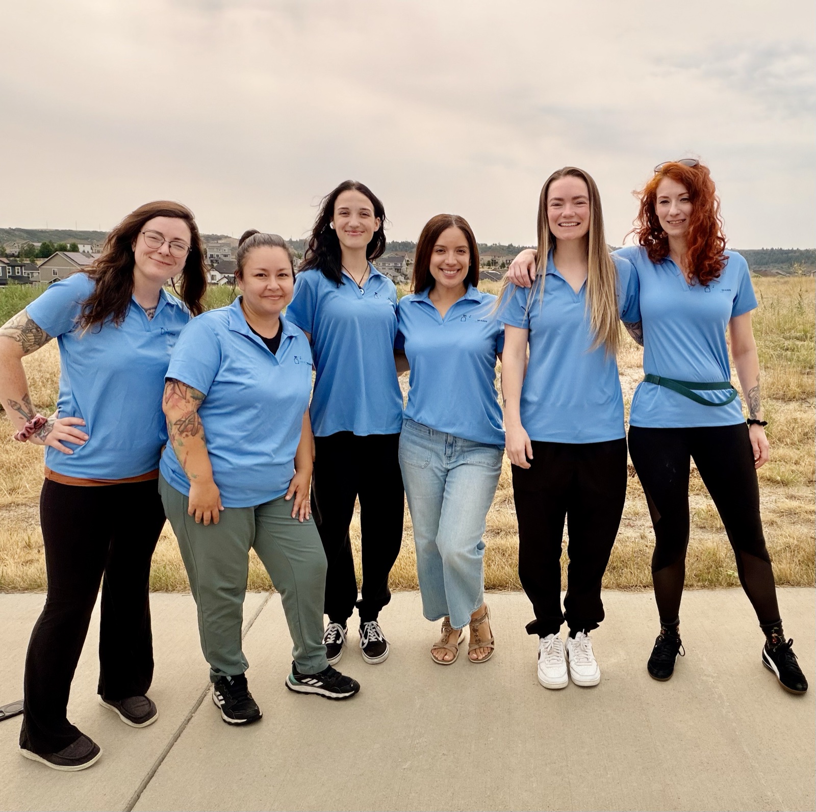 The Snow Maids LLC cleaning team standing together outdoors